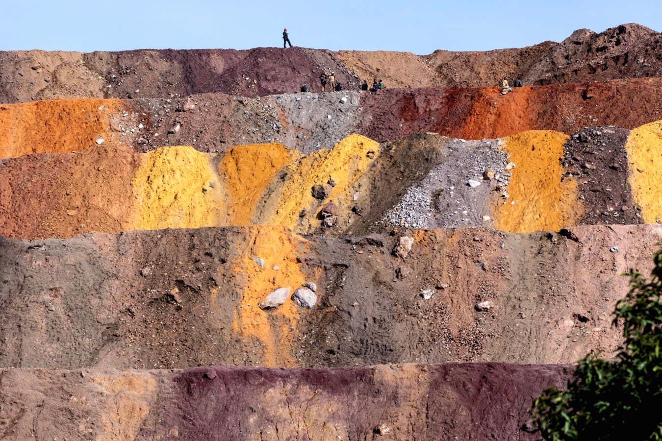 In the village of Tshabula, villagers search for cobalt and copper in the waste tailings dumped by the lorries of the Chinese company Commus, which extracts minerals from one of the town's largest open-cast mines.
