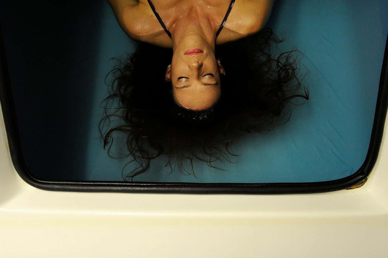 A woman rests in a flotation tank