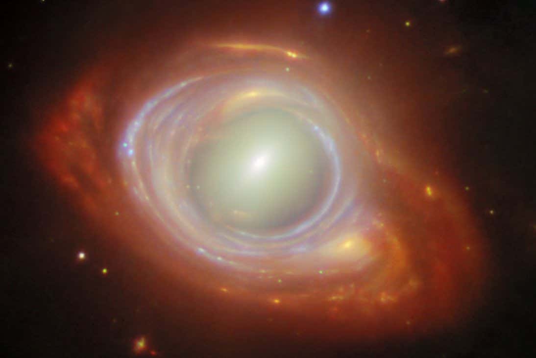 This new NASA/ESA/CSA James Webb Space Telescope Picture of the Month features a rare cosmic phenomenon called an Einstein ring. What at first appears to be a single, strangely shaped galaxy is actually two galaxies that are separated by a large distance. The closer foreground galaxy sits at the center of the image, while the more distant background galaxy appears to be wrapped around the closer galaxy, forming a ring.?? Einstein rings occur when light from a very distant object is bent (or ???lensed???) about a massive intermediate (or ???lensing???) object. This is possible because spacetime, the fabric of the Universe itself, is bent by mass, and therefore light travelling through space and time is bent as well. This effect is much too subtle to be observed on a local level, but it sometimes becomes clearly observable when dealing with curvatures of light on enormous, astronomical scales, such as when the light from one galaxy is bent around another galaxy or galaxy cluster. When the lensed object and the lensing object line up just so, the result is the distinctive Einstein ring shape, which appears as a full circle (as seen here) or a partial circle of light around the lensing object, depending on the precision of the alignment. Objects like these are the ideal laboratory in which to research galaxies too faint and distant to otherwise see. The lensing galaxy at the center of this Einstein ring is an elliptical galaxy, as can be seen from the galaxy???s bright core and smooth, featureless body. This galaxy belongs to a galaxy cluster named SMACSJ0028.2-7537. The lensed galaxy wrapped around the elliptical galaxy is a spiral galaxy. Even though its image has been warped as its light travelled around the galaxy in its path, individual star clusters and gas structures are clearly visible. The Webb data used in this image were taken as part of the Strong Lensing and Cluster Evolution (SLICE) survey (programme 5594), which is led by Guillaume Mahler at University of