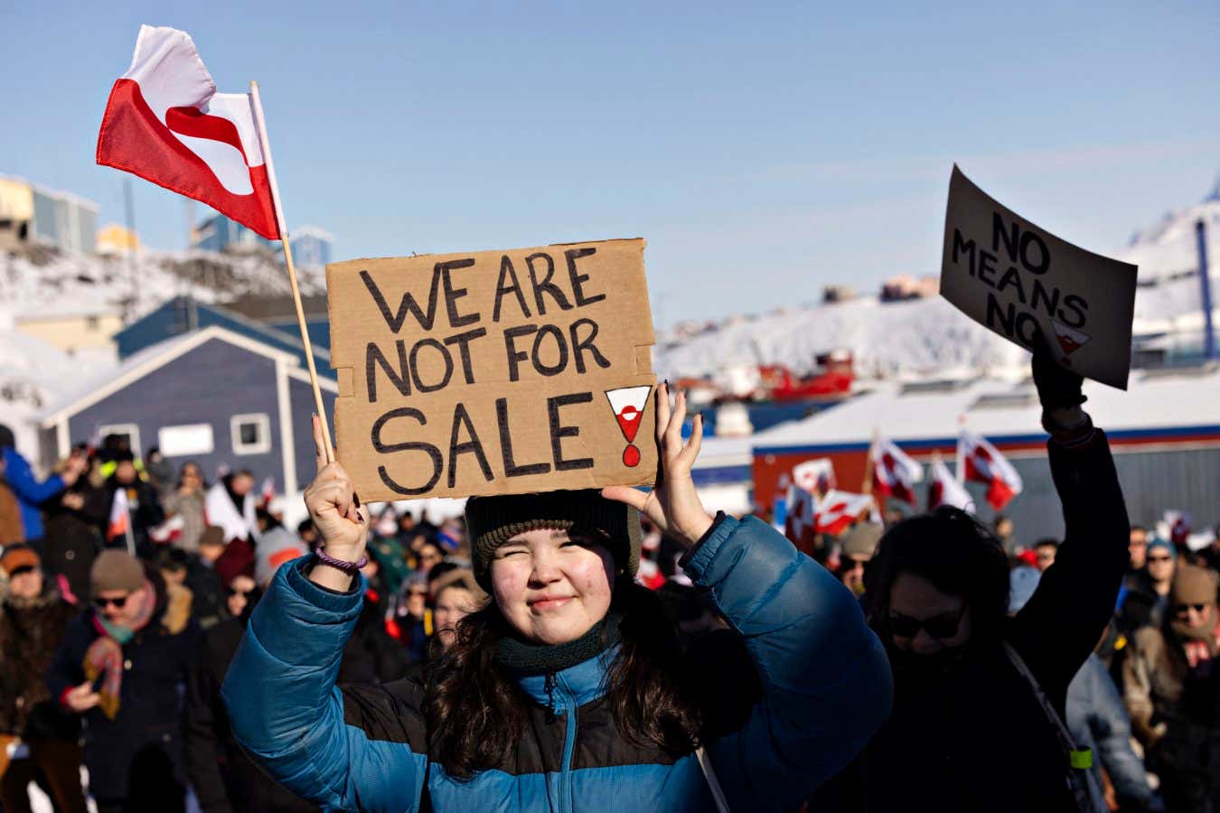 A protester holds a sign reading 'We are not for sale' in front of the US consulate in Nuuk, Greenland