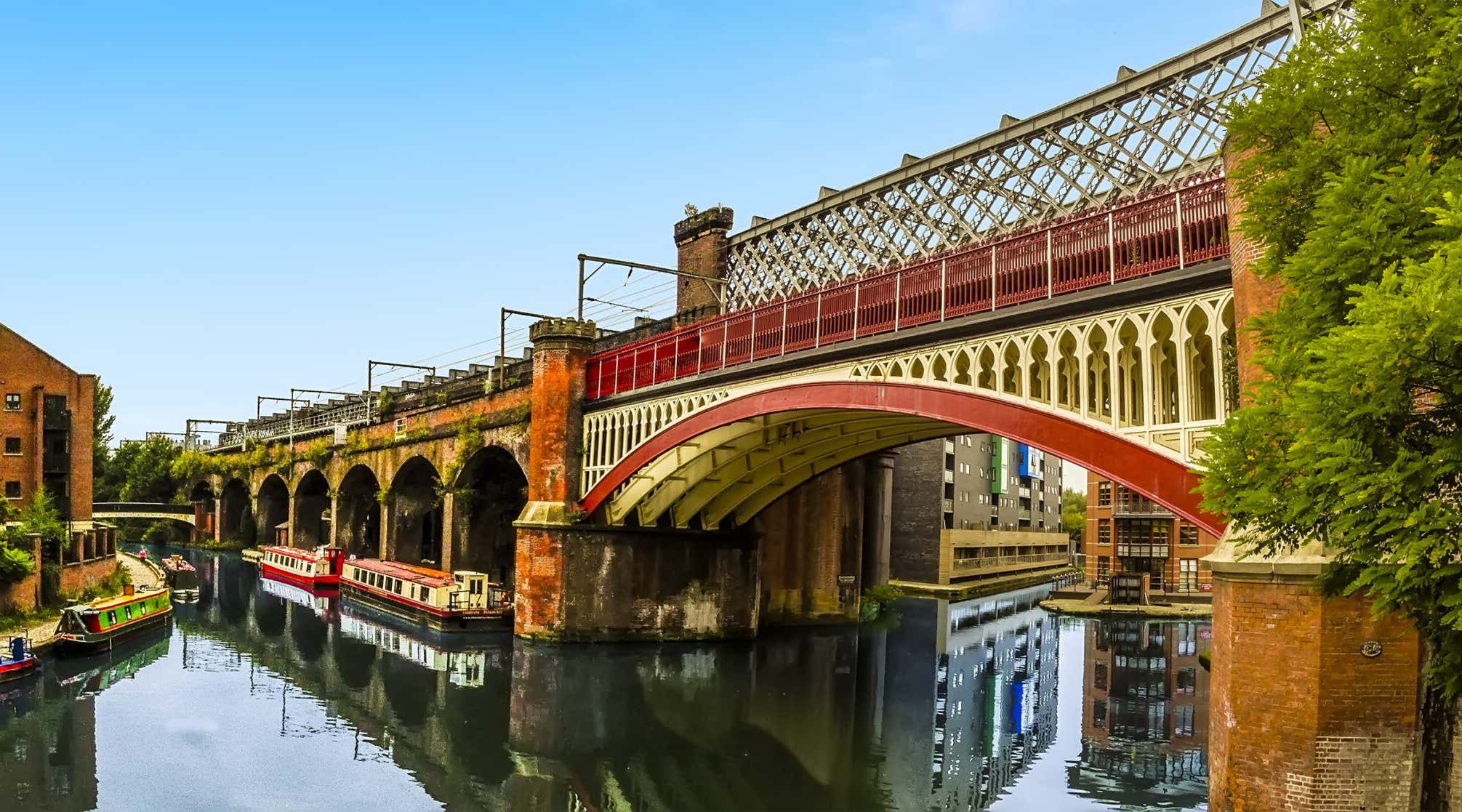 A view along a railway viaduct in the restored Victorian canal system in Castlefield, Manchester, UK
